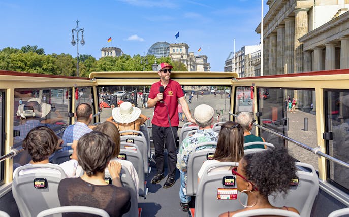 Participants on a Big Bus Berlin tour listen to a guide near the Reichstag building.
