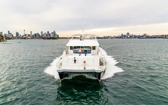 Cruise ship on Sydney Harbour with city skyline in the background.