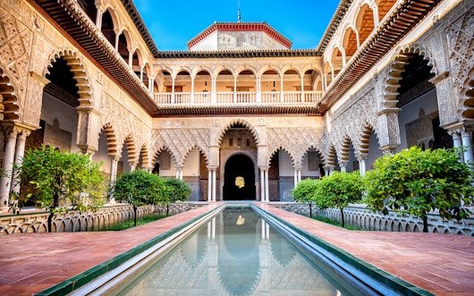 https://cdn-imgix.headout.com/media/images/975b5d5c2729d486bb7398731b95dc33-1455-seville-000-seville-%7C-alcazar-of-seville-01.jpg?auto=format&fit=clip&h=331.2&q=90&w=588.6