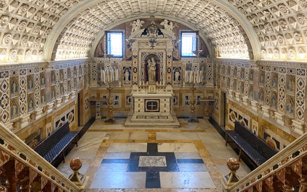 Cagliari Cathedral crypt with ornate ceiling and altar, part of the Cagliari underground tour.
