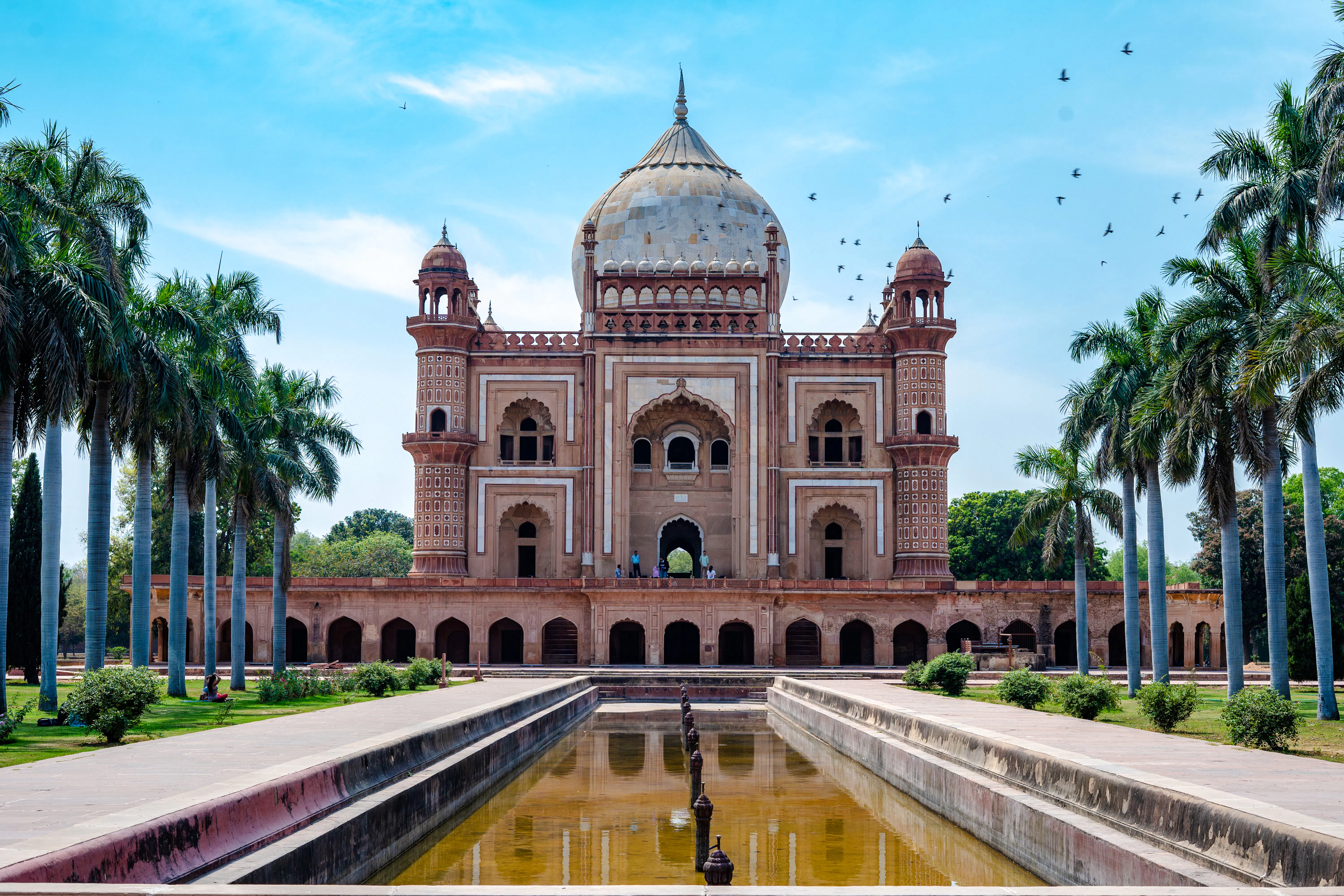 Safdarjung Tomb in Delhi with palm trees and reflecting pool.