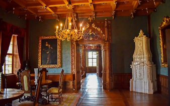 Interior of Trakošćan Castle in Croatia with ornate chandelier and historic furnishings.