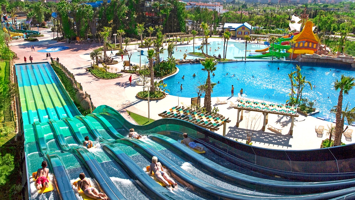 Water park rides at Costa Caribe Aquatic Park, featuring colorful slides and splash zones, Barcelona.