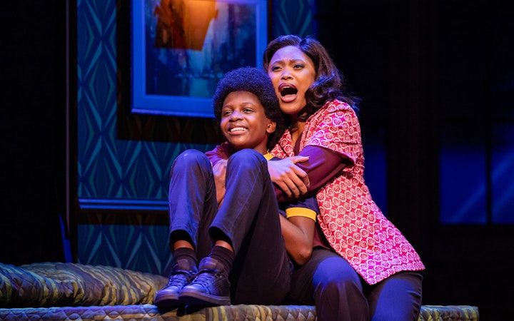 Stage scene from MJ the Musical in Brisbane, featuring two actors embracing on a bed.