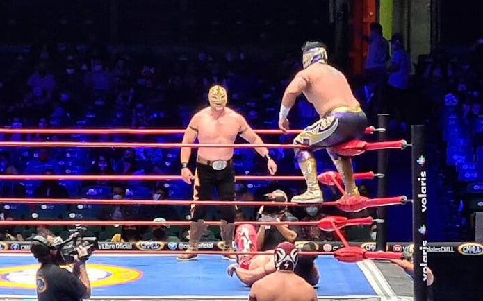 Wrestlers in a Lucha Libre match in Mexico City arena.