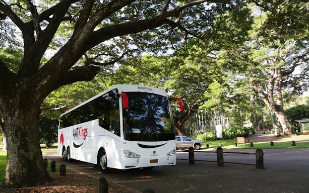 Tour bus parked under trees for Adelaide River Jumping Crocodile Cruise.
