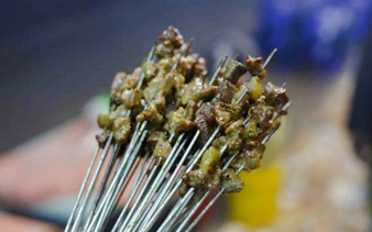 Skewers of grilled meat on a Dar es Salaam food tour, Zanzibar.