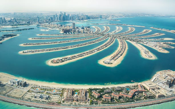 Aerial view of Palm Jumeirah in Dubai, showcasing the iconic palm-shaped island and city skyline.