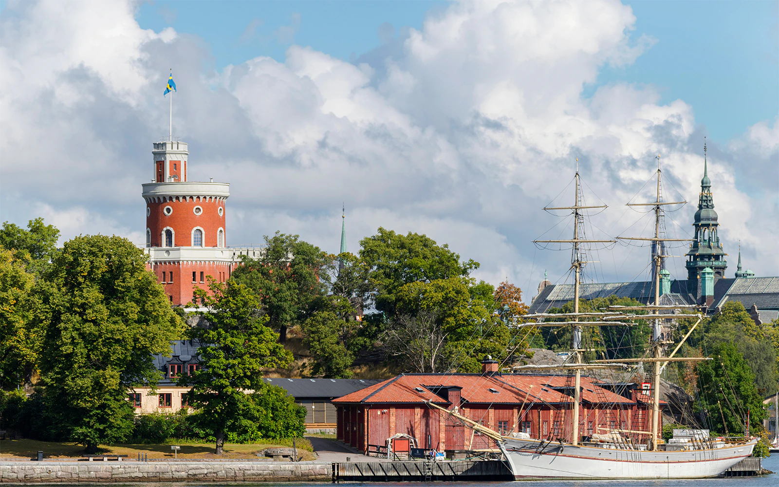 Skeppsholmen island with Kastellet tower and a historic ship in Stockholm.