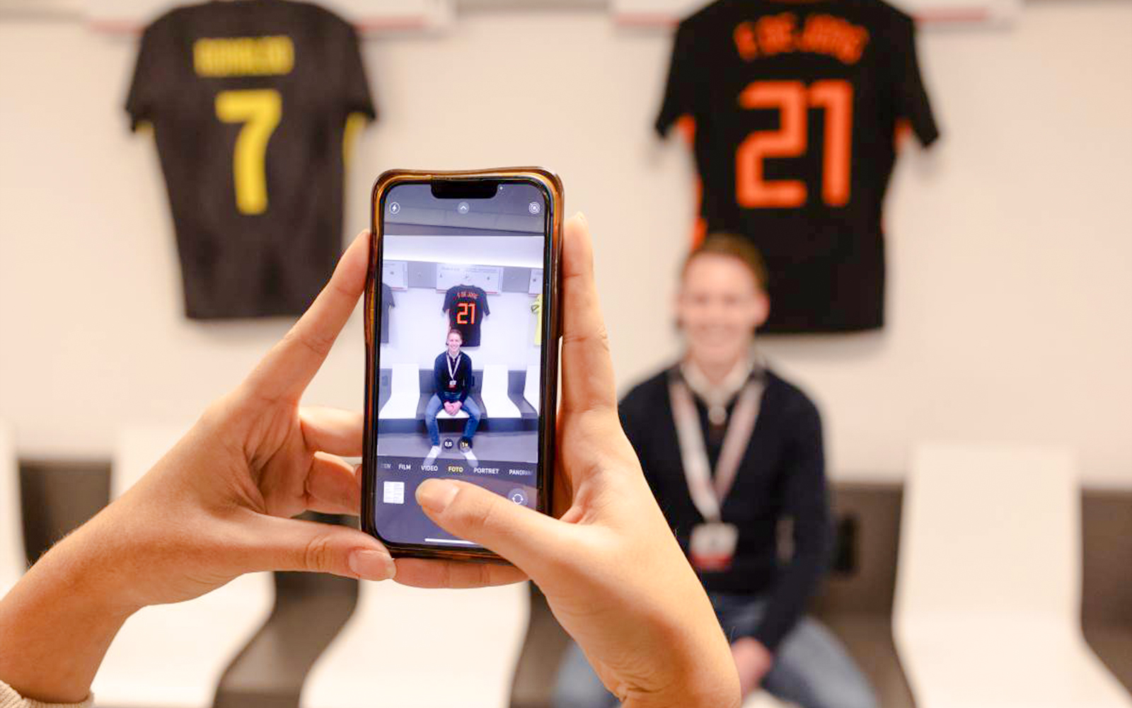 Person photographed in Johan Cruijff ArenA locker room during stadium tour.