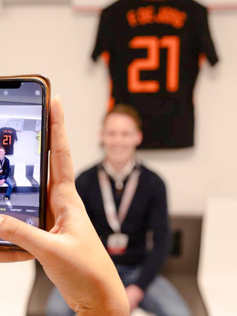 Person photographed in Johan Cruijff ArenA locker room during stadium tour.