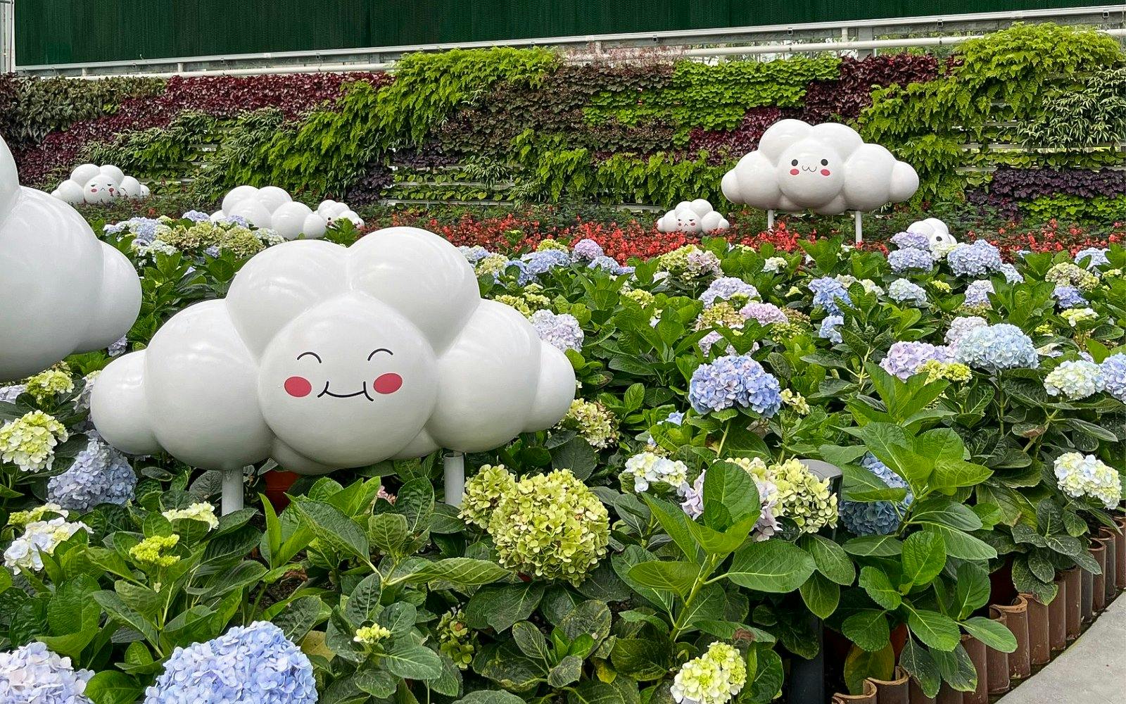 Whimsical cloud sculptures among hydrangeas at Eufloria Gardens & Sculpture Park.