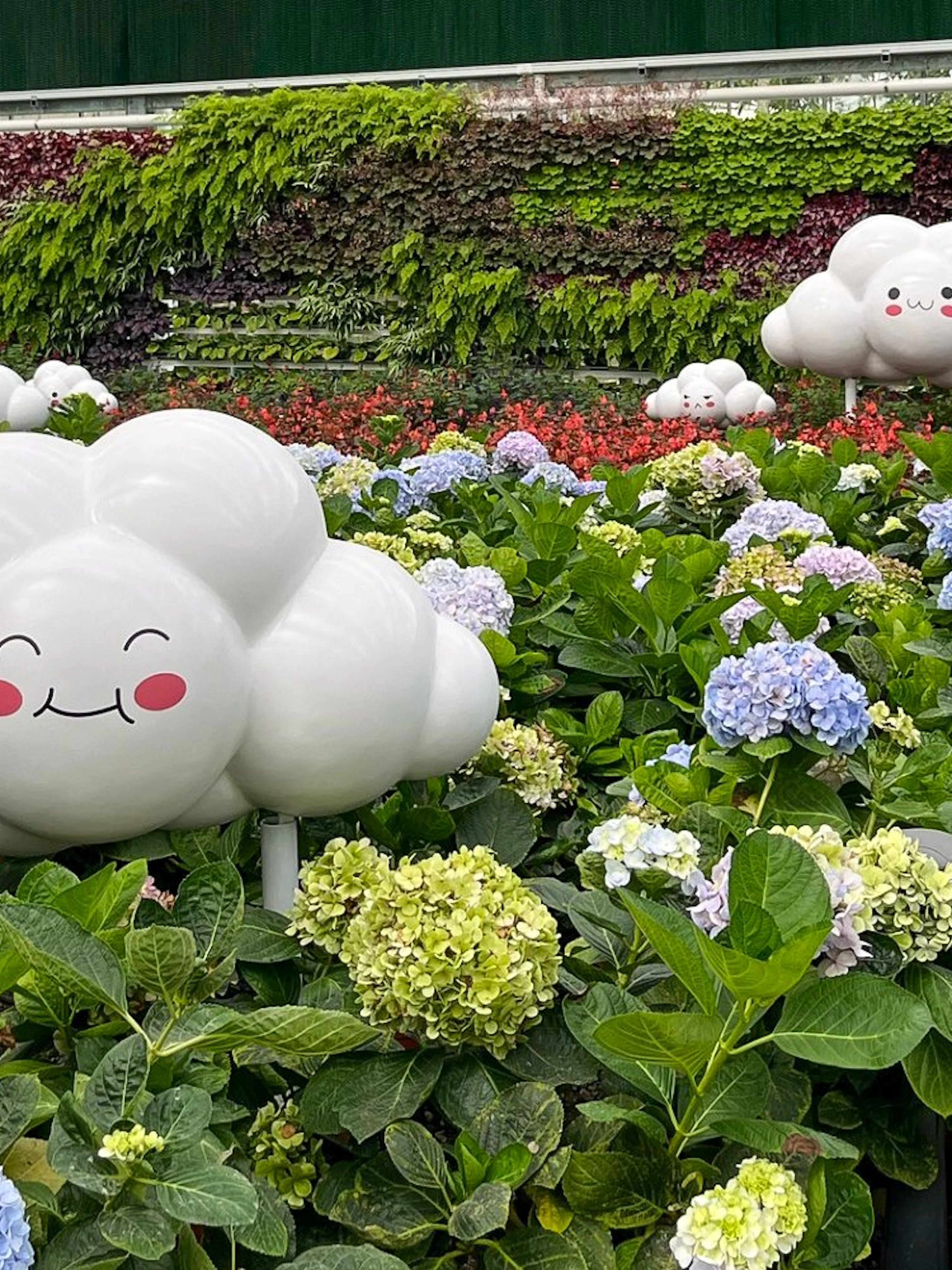 Whimsical cloud sculptures among hydrangeas at Eufloria Gardens & Sculpture Park.