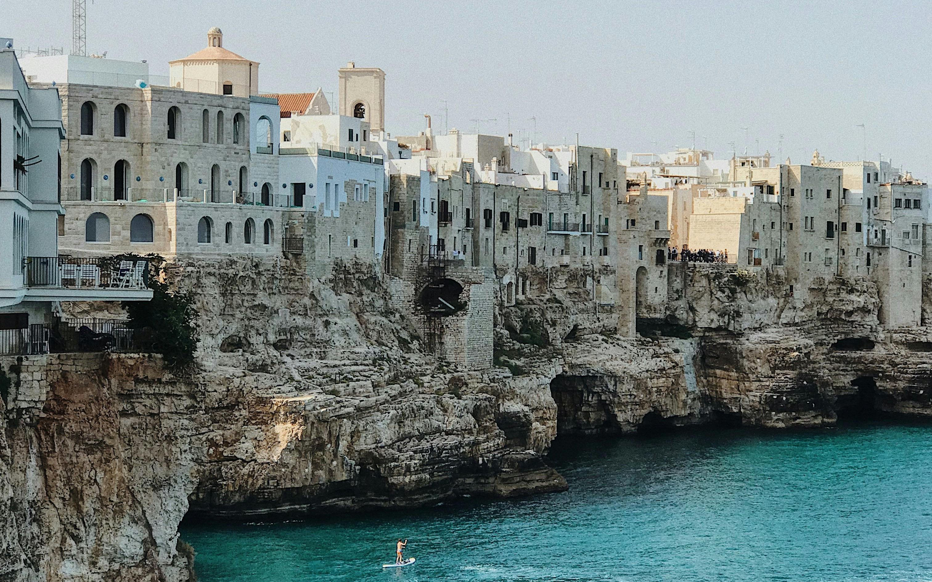 Cliffside buildings overlooking the sea in Polignano a Mare, Italy.