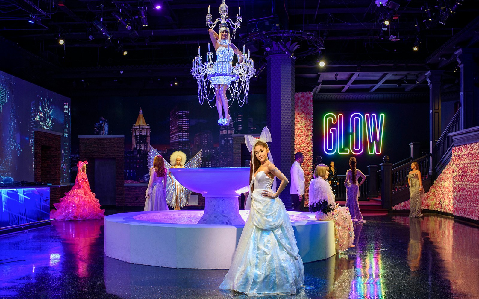 Wax figures of music artists at Madame Tussauds New York, featuring Ariana Grande and Sia.