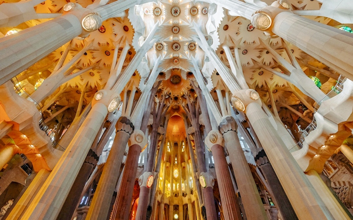 Sagrada Familia interior view of ornate columns and ceiling in Barcelona.