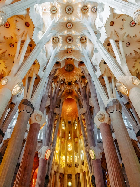 Sagrada Familia interior view of ornate columns and ceiling in Barcelona.