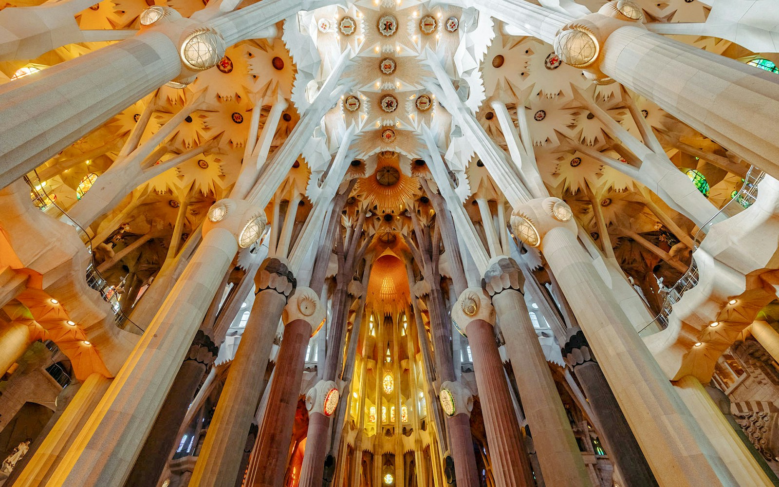 Sagrada Familia interior with Gaudi's intricate columns and stained glass windows, Barcelona.