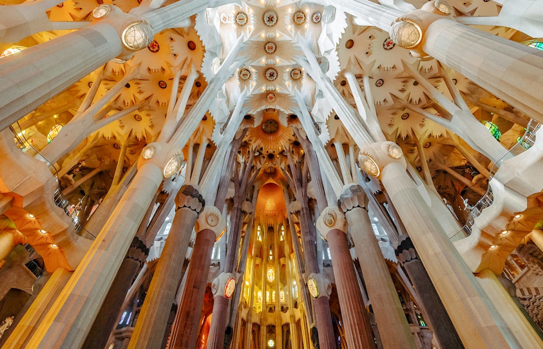 Sagrada Familia interior view of ornate columns and ceiling in Barcelona.