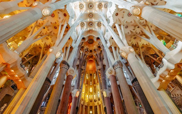 Sagrada Familia interior view of ornate columns and ceiling in Barcelona.