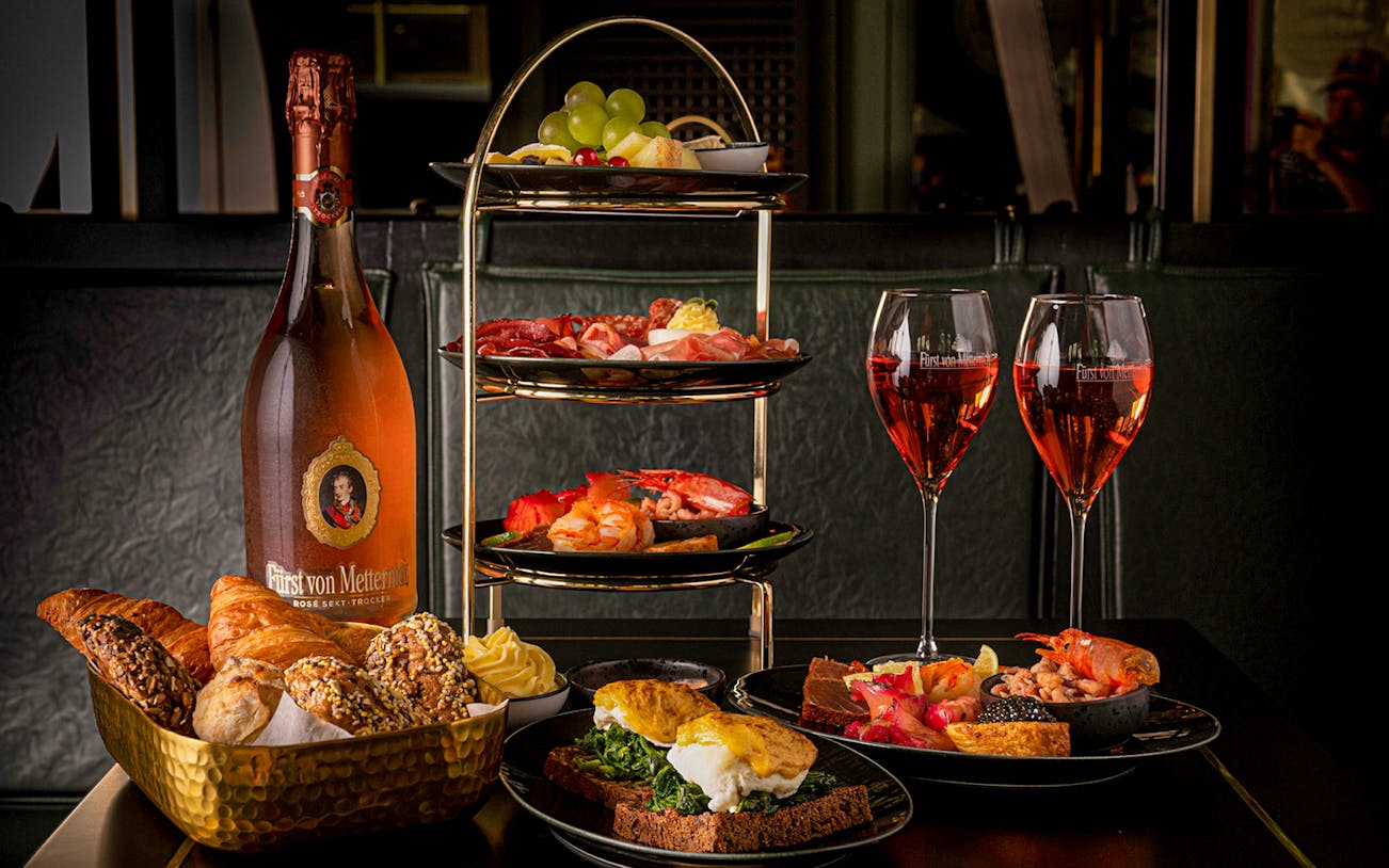 Breakfast spread with pastries, seafood, and sparkling wine at Café Wintergarten.