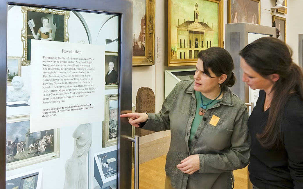 Visitors engaging with an exhibit at New York Historical Society.