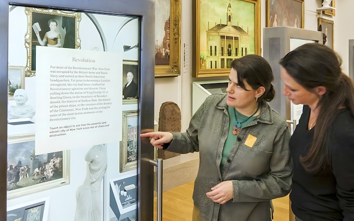 Visitors engaging with an exhibit at New York Historical Society.