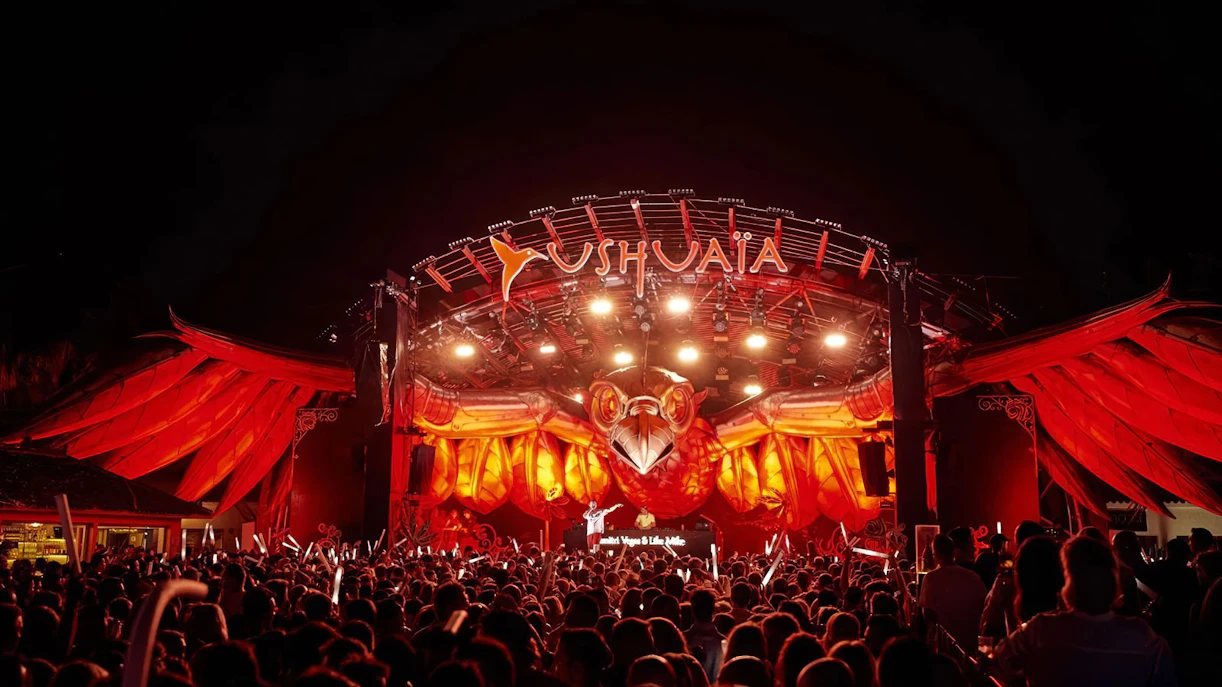 Crowd enjoying Tomorrowland performance at Ushuaïa Ibiza with illuminated stage.