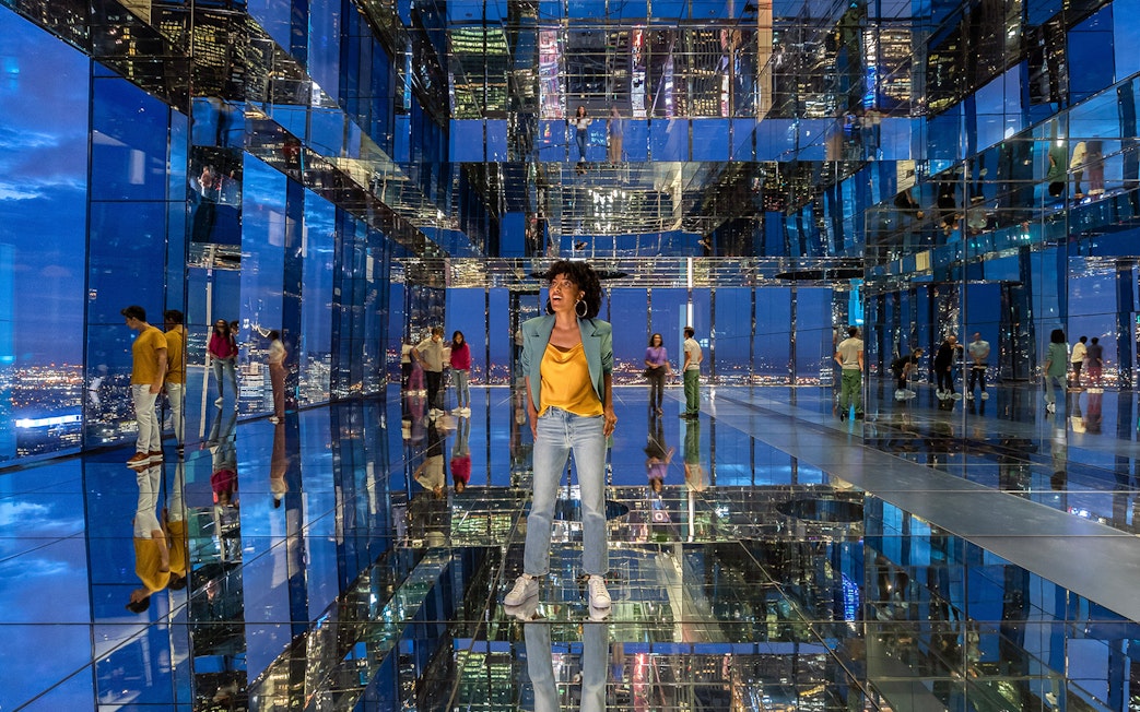 Visitors exploring mirrored observation deck at Summit One Vanderbilt, New York City.