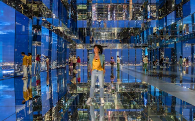 Visitors exploring mirrored observation deck at Summit One Vanderbilt, New York City.