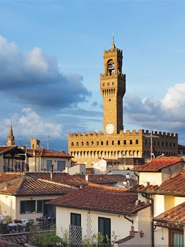 Palazzo Vecchio tower rising above Florence rooftops, Italy.