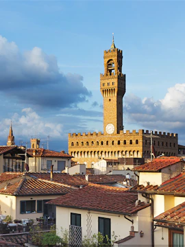 Palazzo Vecchio tower rising above Florence rooftops, Italy.