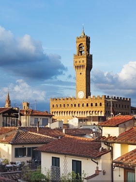 Palazzo Vecchio tower rising above Florence rooftops, Italy.