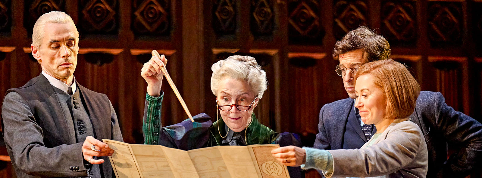 Actors on stage examining a map in "Harry Potter and the Cursed Child" play.
