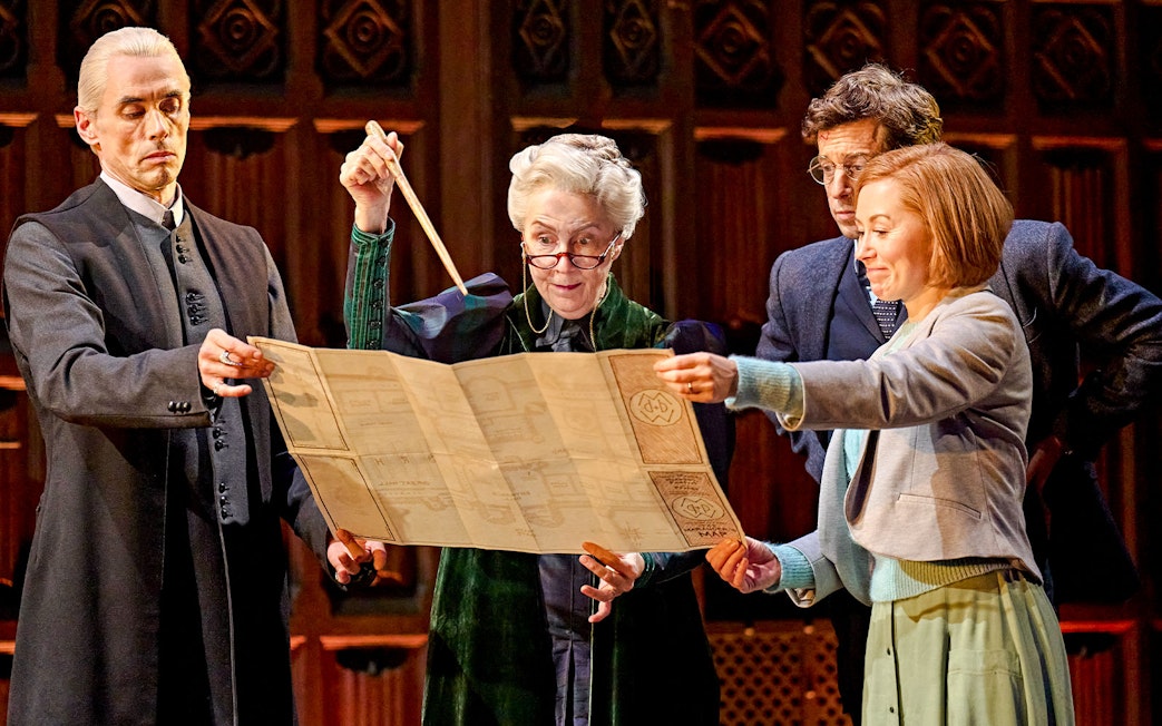 Actors on stage examining a map in "Harry Potter and the Cursed Child" play.