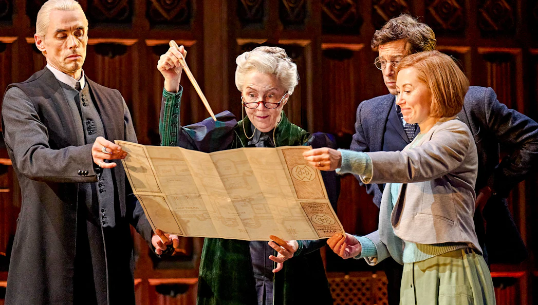 Actors on stage examining a map in "Harry Potter and the Cursed Child" play.