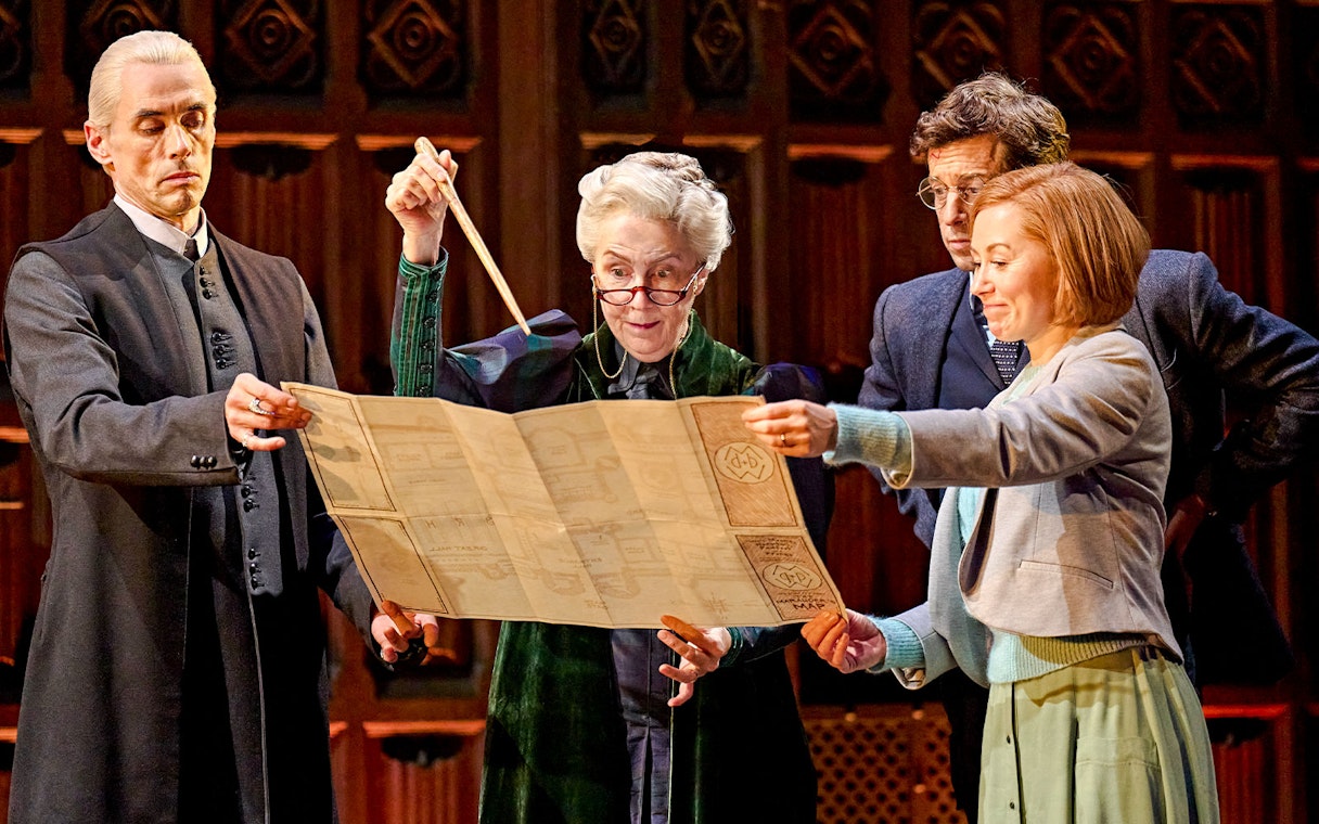 Actors on stage examining a map in "Harry Potter and the Cursed Child" play.
