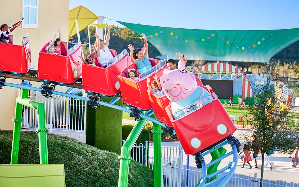 Kids and family enjoying mini rollercoaster at Peppa Pig Park, Guntzburg.