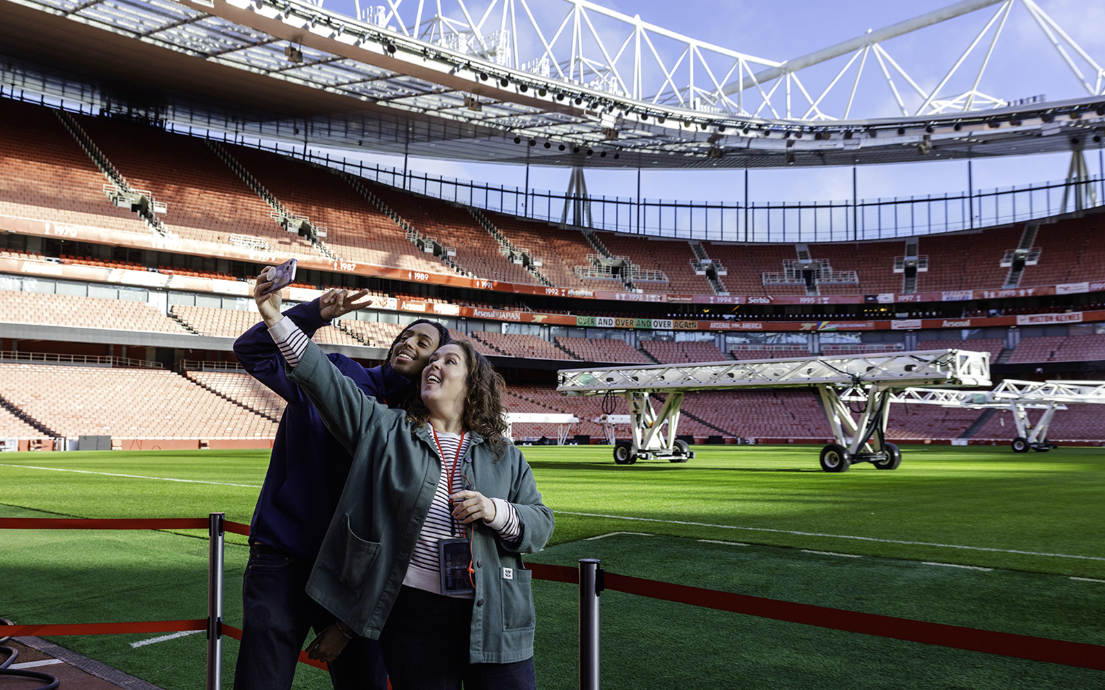 Guests taking a selfie by the pitch side at Emirates Stadium.