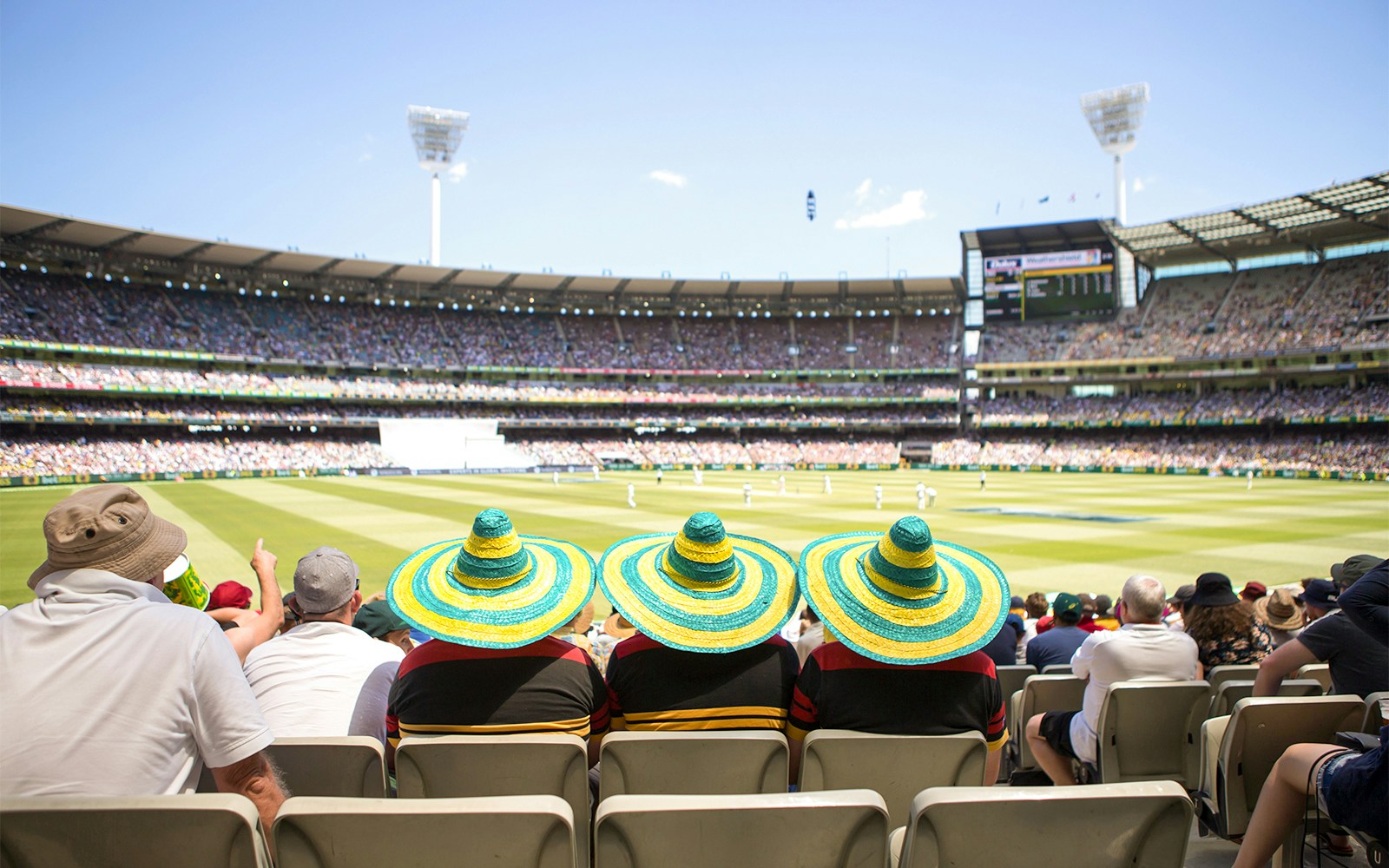 Melbourne Cricket Ground interior view with guided tour group exploring stadium.