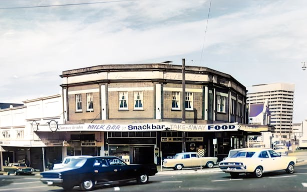 Fortitude Valley street scene with vintage cars and historic milk bar.