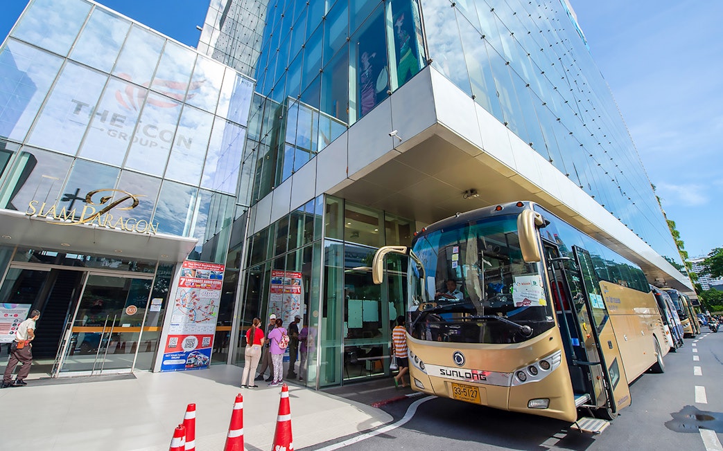 Tour buses parked outside Siam Paragon, Bangkok, for Amphawa Floating Market & Maeklong Railway Market tour.