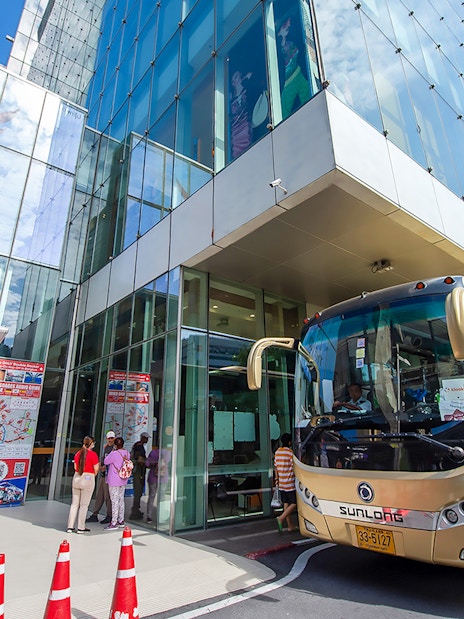 Tour buses parked outside Siam Paragon, Bangkok, for Amphawa Floating Market & Maeklong Railway Market tour.