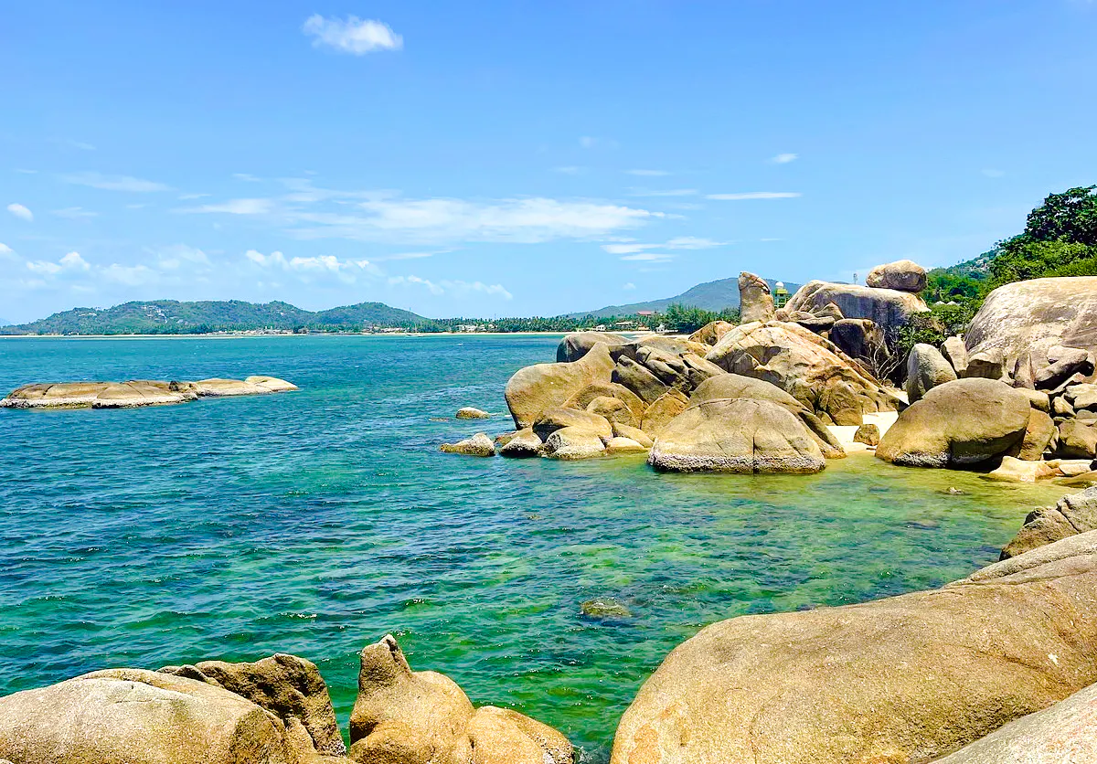 Rocky coastline with clear blue water on Koh Samui island, Thailand.