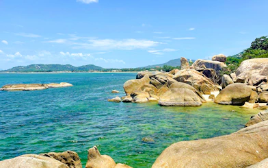 Rocky coastline with clear blue water on Koh Samui island, Thailand.