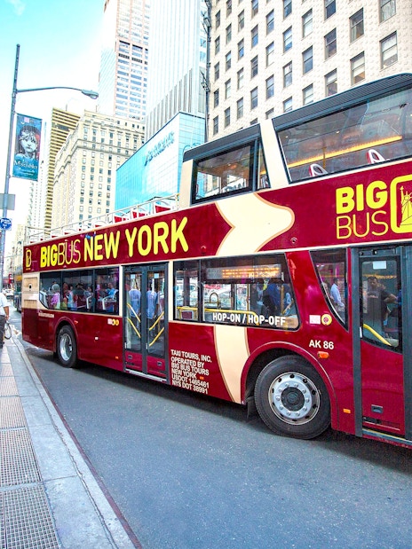 Big Bus hop-on hop-off tour bus in New York City street.