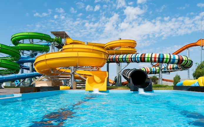 Water slides at Aqualand in Albufeira with colorful tubes and splash pool.