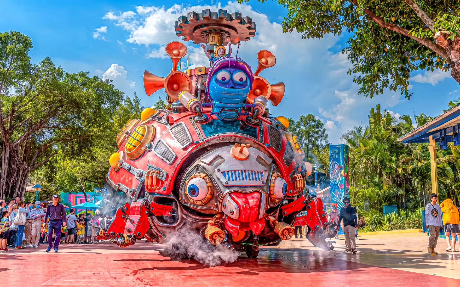 Colorful parade float with robot character at Chimelong Paradise, surrounded by visitors.