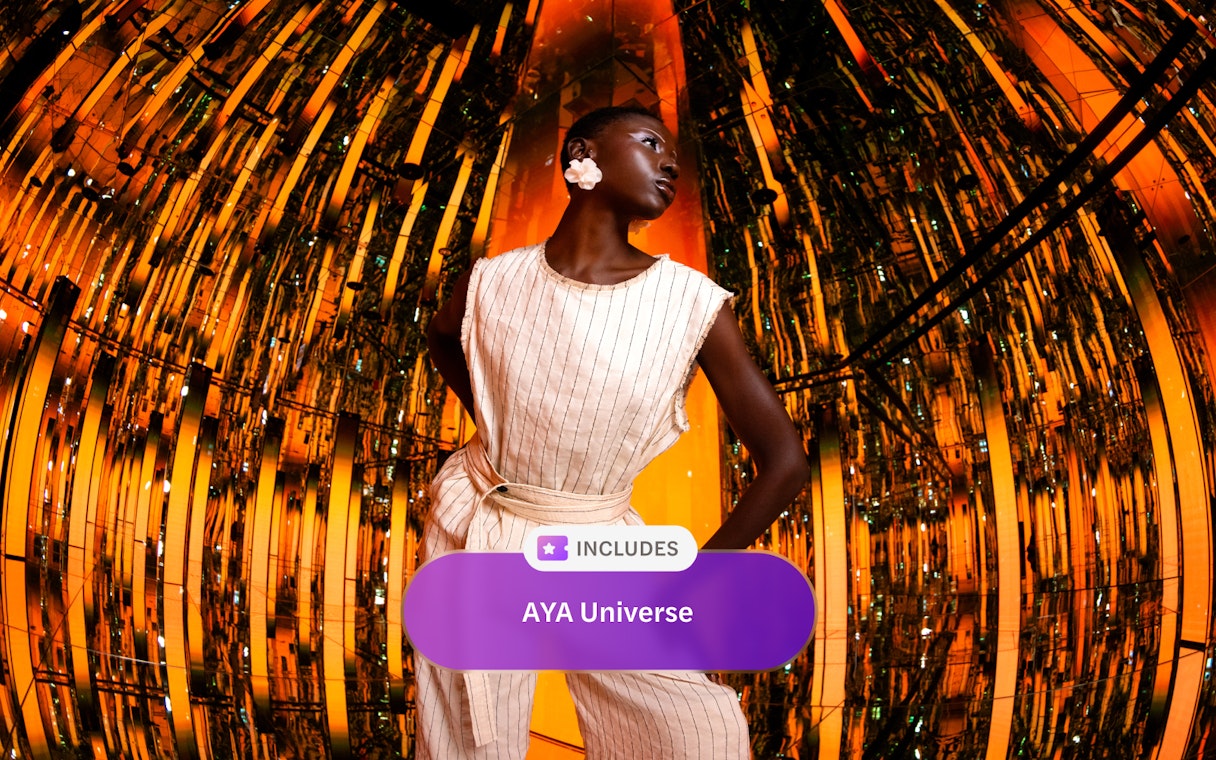 Reflective orange and gold room at AYA Universe with a person standing in the center.