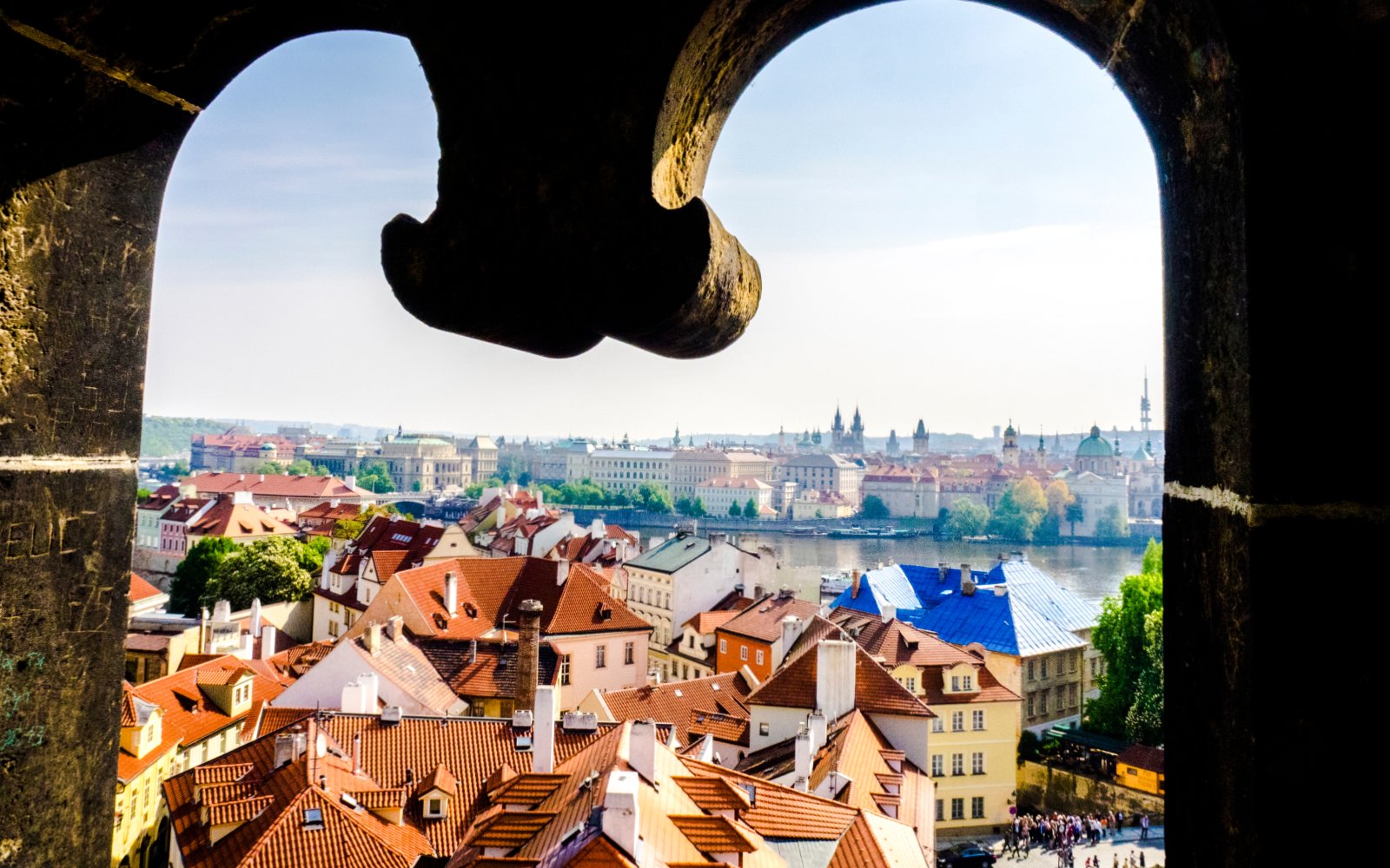 View of Prague's Lesser Town rooftops and Vltava River from Charles Bridge Tower.
